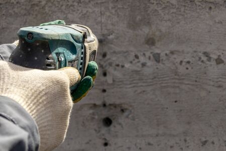 People are using electric drill,He drilled concrete to put steel anchor.の写真素材