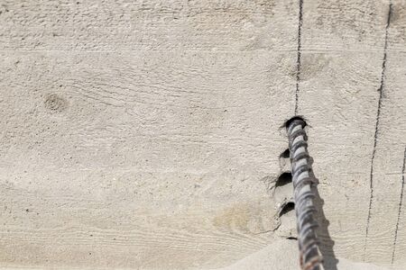 People are using electric drill,He drilled concrete to put steel anchor.