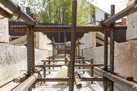 Foundation site of new house, building, details and reinforcements with steel bars and wire rod, preparing for cement pouringの写真素材