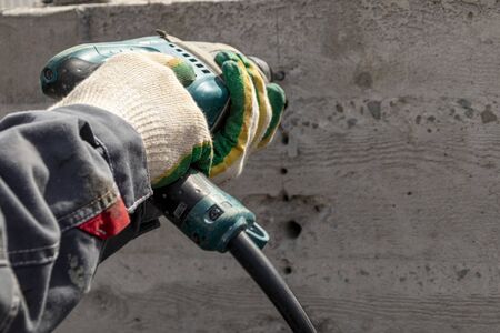 People are using electric drill,He drilled concrete to put steel anchor.の写真素材