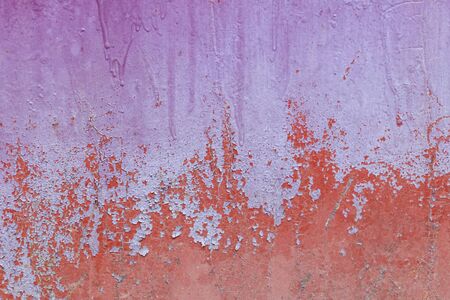Old weathered painted wall background texture. Red dirty peeled plaster wall with falling off flakes of paint.の写真素材