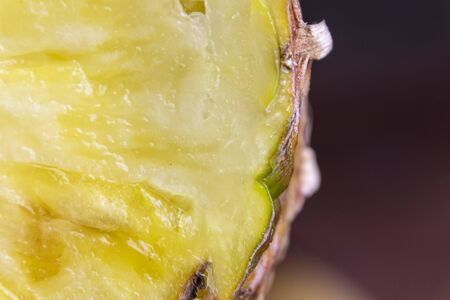 Ripe pineapple and pineapple slices on a wooden background tropical fruits.