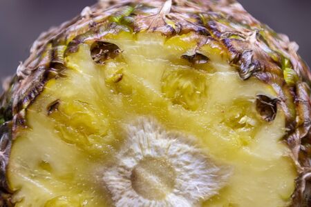 Ripe pineapple and pineapple slices on a wooden background tropical fruits.
