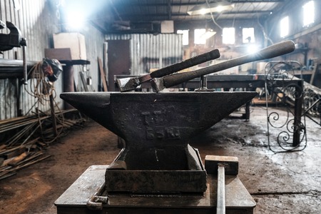 Blacksmiths workplace with horn fire hammer anvil metalの写真素材