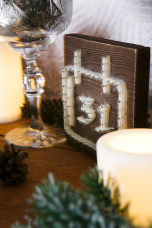 New Year decorations, a Christmas tree, garlands and balls home cosiness with a fireplace and candlesの写真素材