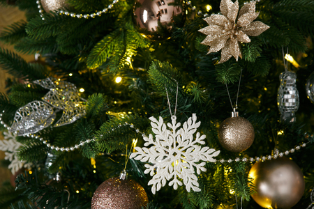 New Year decorations, a Christmas tree, garlands and balls home cosiness with a fireplace and candlesの写真素材