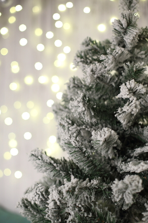 New Year decorations, a Christmas tree, garlands and balls home cosiness with a fireplace and candlesの写真素材