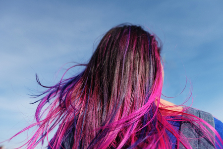Girls with colored hair. Colored hair coloring, blue pink purple, lilac color. Hair blows the wind, walk along the city street and in the woods on a sunny day.の写真素材