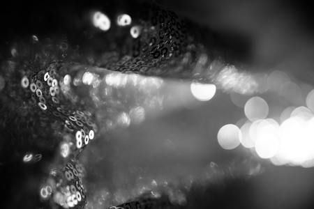 Smooth wawed tissue fabric folded on background. Colorless, gray, desaturated or black and white....