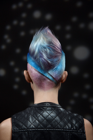 Studio fashion creative model portrait with short colored blue and gray hair and a scar on the chest. Hairdressing, style, shaved head, the image of punk, rocker, gangster.の写真素材