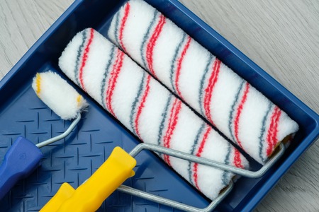 Tools for repair. Paint, brushes, roller, all for painting rooms inside the house.の写真素材
