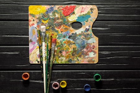The tools of the artist, brushes, paints and palette not dark wooden background. Abstract conceptual background with place for text.の写真素材