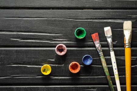The tools of the artist, brushes, paints and canvas are not dark wooden background. Abstract conceptual background with place for text.の写真素材