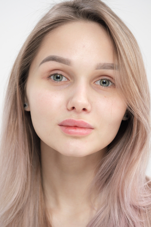 Close-up of the face of a beautiful young blonde girl with smooth skin. Natural skin without make-up.の写真素材