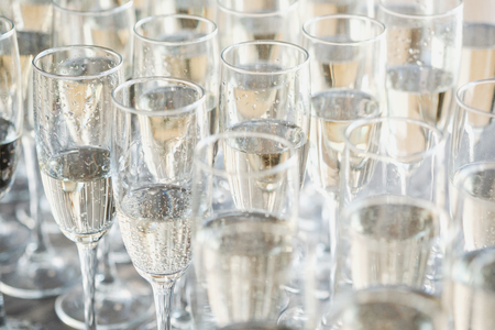 A row of glasses of champagne on a light background. Buffet concept and event organization. Welcome drink.の写真素材