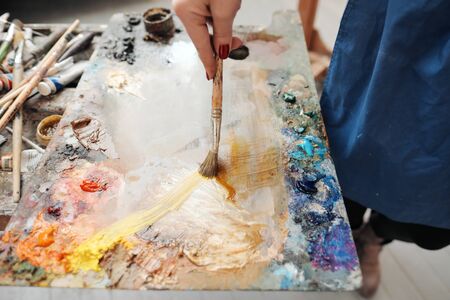 Brushes in the hands of the artist's women. Drawing and art. Creative profession and inspiration.の写真素材