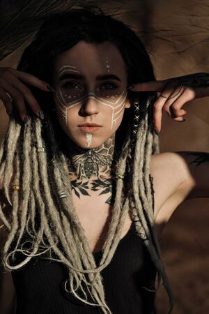 Beautiful sexy woman in black underwear. The body is covered with many tattoos. On the head...