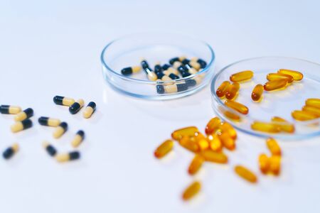 Various medical pills are on a white background. Vitamins, hemeopathy and bioactive additive against drugs.の写真素材