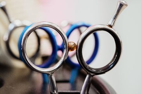 Hairdressing tools on white and pinksilver background. Scissors close up.