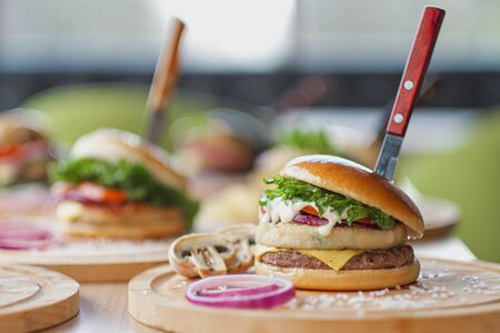 Fast food restaurant. Lots of different burgers and beer bottles on the table at the window restaurant. Party, lunch.の写真素材