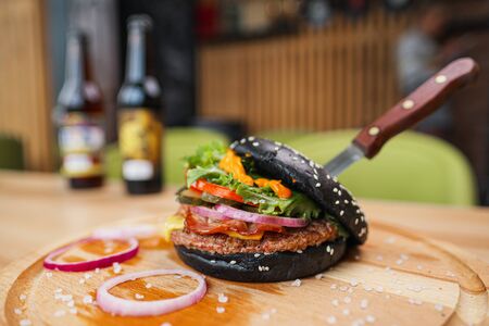 Fast food restaurant. Lots of different burgers and beer bottles on the table at the window restaurant. Party, lunch.の写真素材