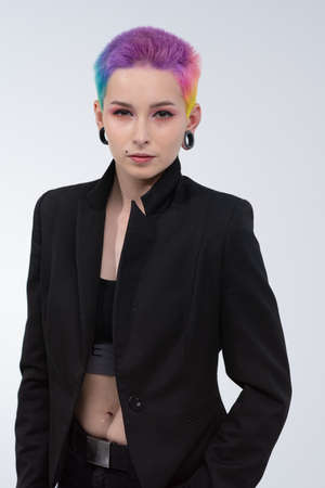 A young beautiful girl with short colored hair. Spread bright coloring and creative make-up....
