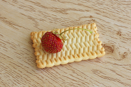 Biscuits with strawberry lying on a wooden table. Close-up.の写真素材