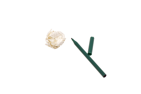 A crumpled piece of paper and a green felt-tip pen. Isolated on white.の写真素材