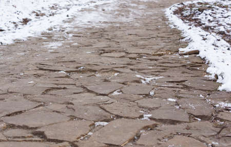 Road stone slabs in winter. Close-up.の写真素材