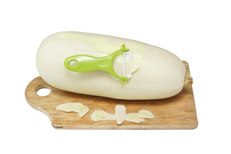 Hands peeled zucchini. Isolated on white.の写真素材