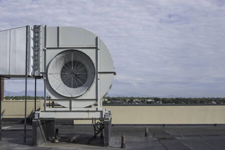 Commericial ventilation fan on a rooftop of a high rise building side view