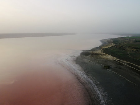 red salt lake in the fog in the morning