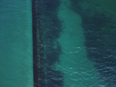Beach and waves from top view. Turquoise water background from top view.