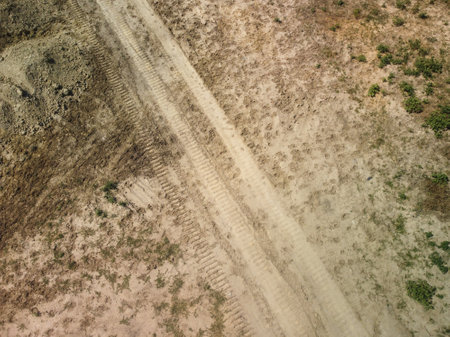 Scenic view on the gravel road with stones and vegetation on roadsidesの写真素材