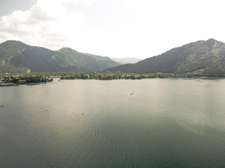 Panoramic view of deep blue Lake Lugano in Switzerland surrounded by mountainsの写真素材