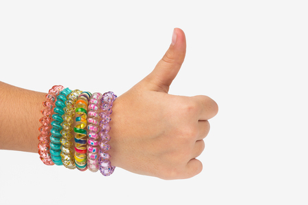 Hand of a child on a white background shows a thumb upの写真素材