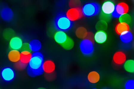 Beautiful festive colorful bokeh on a dark backgroundの写真素材