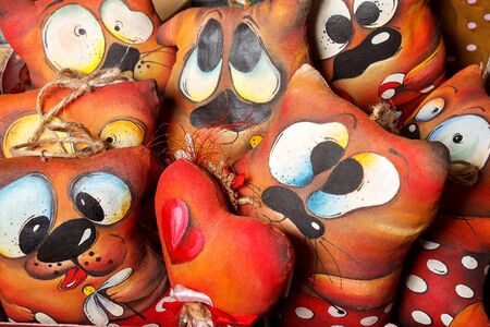 Soft toys in the form of a dog like valentines with various cheerful facesの写真素材