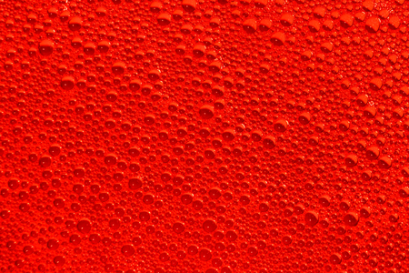 red liquid soap bubbles as background