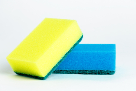Yellow and blue sponges for washing dishes on white backgroundの写真素材