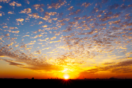 Colorful and beautiful sunset over an industrial cityの写真素材
