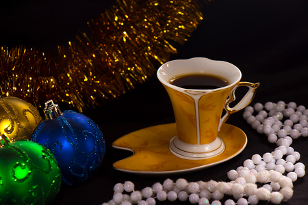 Cup of coffee on a dark background with Christmas decorations close-upの写真素材