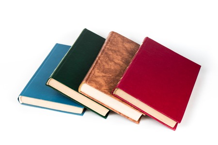 Multi-colored books lie chaotically in isolated on white background
