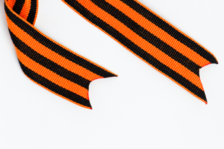 Bant of black and orange ribbons of St. George isolated on white backgroundの写真素材