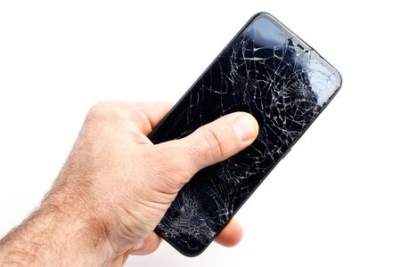 Hand holds a broken smartphone on a white backgroundの写真素材