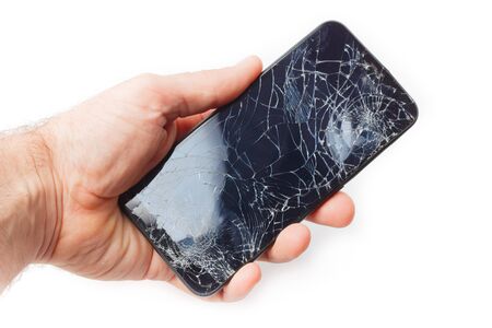Hand holds a broken smartphone on a white backgroundの写真素材