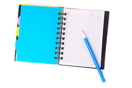 The pen lies on an open notebook isolated on a white background.の写真素材