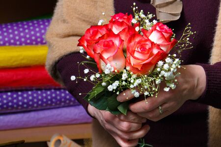 a bouquet of flowers in the hands of a floristの写真素材
