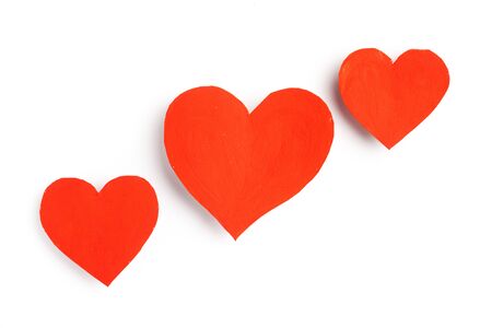 Cute red hearts lie on a white background.の写真素材