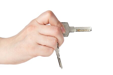 House keys in the female hand on a white backgroundの写真素材